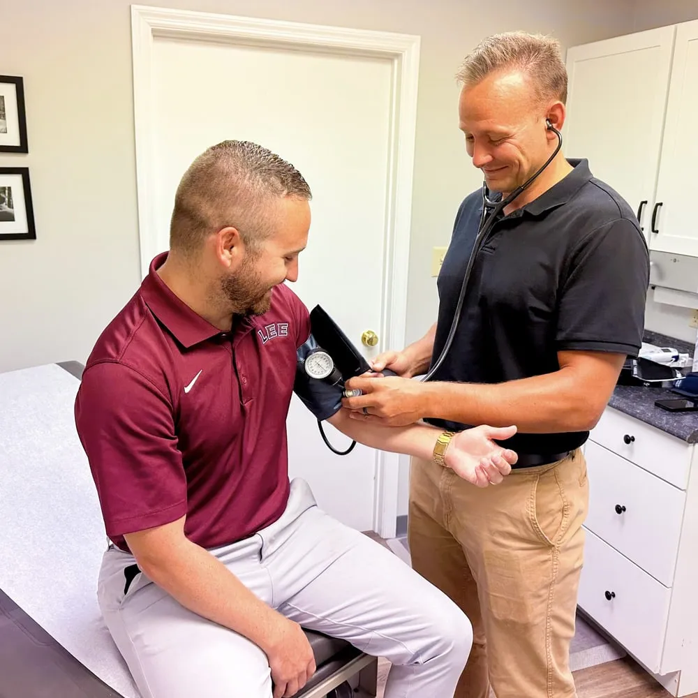 A DPCA provider taking a blood pressure reading during an employee physical